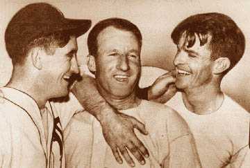 Three Tigers responsible for victory in the 1935 World Series celebrate in the clubhouse after the game. Goose Goslin, center, drove in Mickey Cochrane, left, with the winning run on a bloop single. At right is the winning pitcher, Tommy Bridges. 
